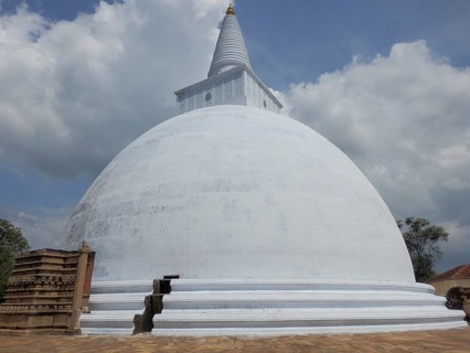 Ruwanwelisaya, white Buddhist stupa rising against blue sky with clouds, Anuradhapura, Sri Lanka