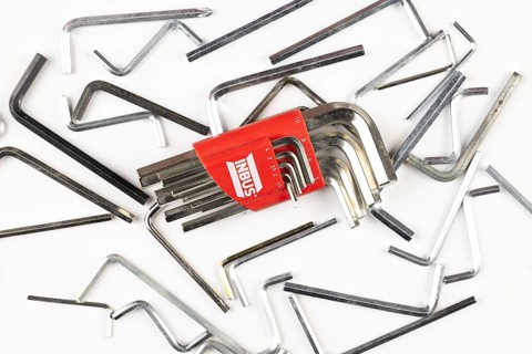 Various L-shaped Allen wrenches scattered on a bright surface