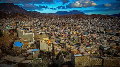 Panorama, view of Mindelo from above, colorful city on hills with mountains in the background under