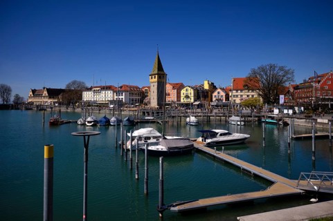 Boat dock, yachts, boats are moored in the harbor, behind it Mangturm, Hotel Bayerischer Hof, Hotel