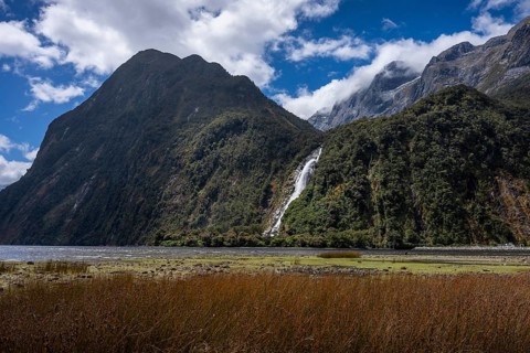 The Bowen Falls waterfall with the Cascade Peak and Barren Peak mountains. Milford Sound, Fiordland