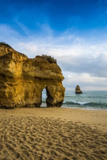Rocky coast with beach and red rocks, Praia do Camilo, Lagos, Algarve, Portugal
