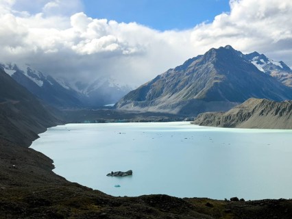 Stunning autumn landscape of Mount Cook in New Zealand, showcasing a serene glacial lake surrounded