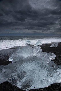 Little icebergs and crushed ice on the black beach at Joekulsarlon glacial lake