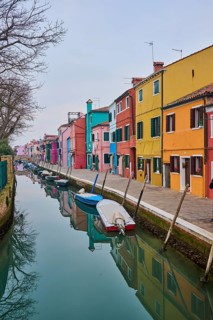 Colorful houses beside the waterway at 'Fondamenta di Terranova' with boats lying in the water on