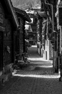 Old farmhouses in the Rue du Village, black and white photo, historic town center, Grimentz, Val
