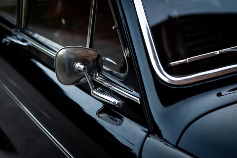 Rear view mirror, vintage car, black Volvo Amazon, mid-size car from Swedish car manufacturer
