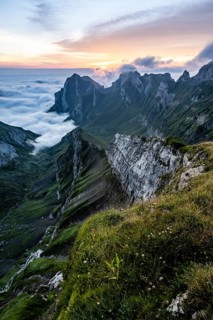 View over Säntis mountains into the valley of Meglisalp at sunrise, high fog in the valley, Säntis,
