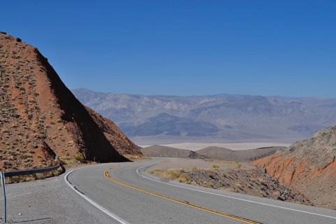 Road winds through barren, mountainous desert landscape, Death Valley National Park, Mojave Desert,