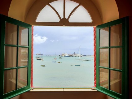 View of the sea through an open window with boats in a quiet atmosphere, Torre de Belem, Mindelo,