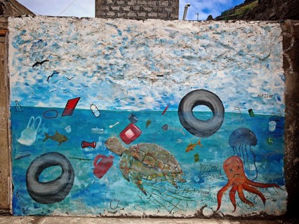 Memorial, colorful graffiti indicates ocean pollution, a mural depicts marine animals and floating