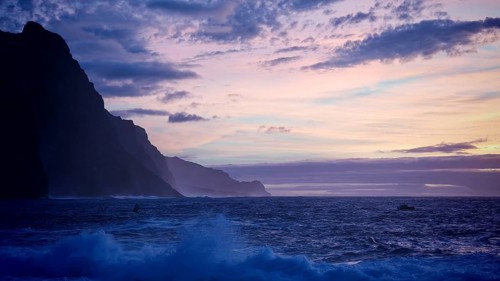 Dusk at sea with cliffs and calm waves in shades of blue and purple, Ponta do Sol, Santo Antao,