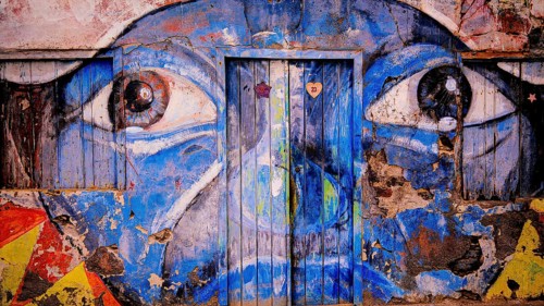 Blue mural on façade and door, graffiti, mural of a face with big eyes, Ponta do Sol, Santo Antao,