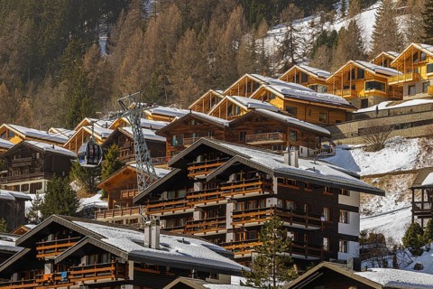Snow-covered hotels and chalets built into the hillside, Grimentz, Val d'Anniviers, Valais Alps,