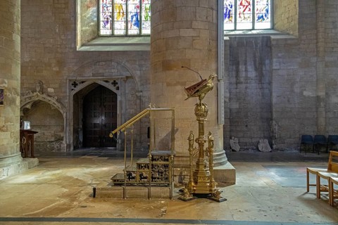 Brass eagle reading desk, interior view, former abbey church, Tewkesbury, Gloucestershire, England,