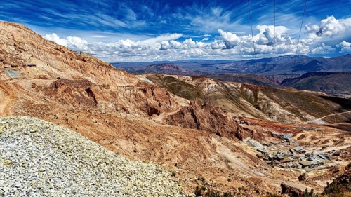 View of a vast mountain valley under a dramatic cloudy sky, The Potosi Silver Mines on Cerro Rico