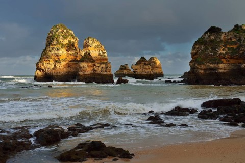 Rock formations on the coast in the evening light, Praia do Camilo, Lagos, Algarve, Portugal