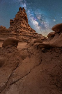 Majestic sandstone structures stand under the glittering Milky Way in Goblin Valley State Park,