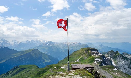 Swiss national flag at the summit of Faulhorn, mountain panorama, Bernese Alps, Bernese Oberland,