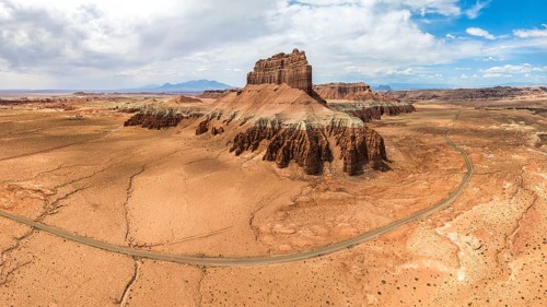 A panoramic aerial shot of Goblin Valley State Park, showcasing the unique sandstone formations and