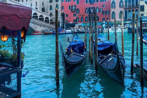 Gondolas anchor in the rain at the Rialto Bridge, Venice, Veneto, Italy