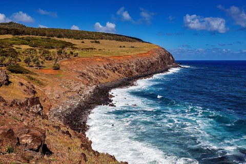 Coastal landscape with rocks and turquoise sea under clear sky, The landscape of Easter Island in