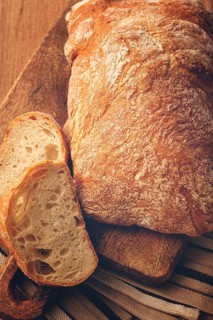 Sliced ciabatta, on a chopping board, italian bread, close-up, Italian cuisine, breakfast, no