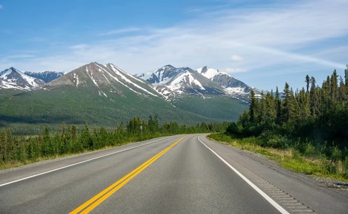 Road through taiga and mountainous landscape, picturesque landscape on Richardson Highway, Alaska,