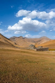 Historic caravanserai Tash Rabat from the 15th century, with yellow hills, Atbashy district in the