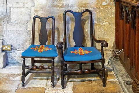 Chairs with decorated cushions, interior view, former abbey church, Tewkesbury, Gloucestershire,