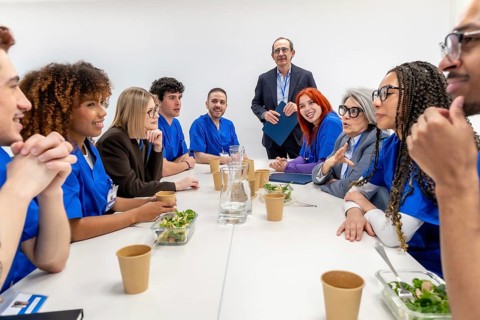 Diverse group of medical professionals, including doctors and nurses, collaborating and discussing