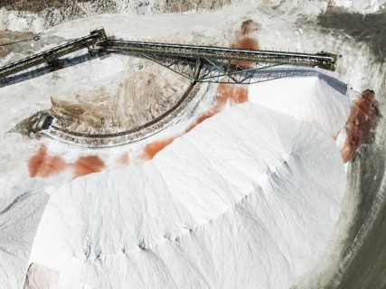 Conveyor belt and salt heaps at the Walvis Bay Salt works. Aerial view. Drone shot. Walvis Bay,
