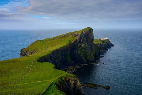 Extensive cliff landscape with a lighthouse at the edge of the ocean, Neist Point Lighthouse,