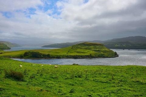 Green hilly landscape by the sea under a cloudy sky, Isle of Skye, Scotland, United Kingdom, Great