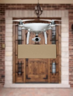 Unmanned Aircraft System (UAV) Quadcopter Drone Delivering Package To House