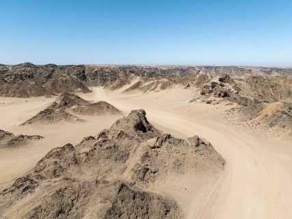 Aerial view, dry barren mountains in Moon Valley, rocky landscape ridged by erosion, Namib-Naukluft