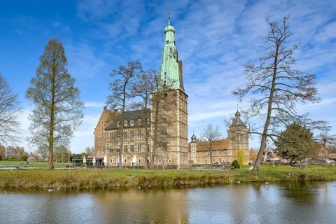 View over moat to historic moated castle from Renaissance Raesfeld Castle in spring, Freiheit