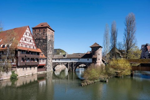 View of the Pegnitz river with the Weinstadel half-timbered building, the water tower and