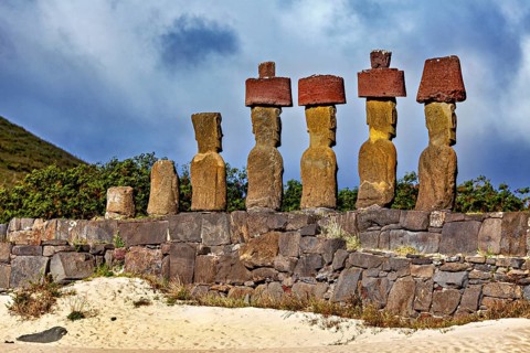 Close-up of Moai statues on Easter Island under a dramatically cloudy sky, The Moai statues on
