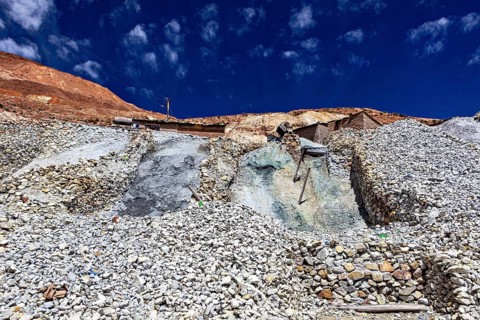 Rubble hills under a deep blue sky with some clouds, The silver mines of Potosi on Cerro Rico in