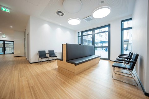 Modern waiting room with wooden floors and minimalist furniture, radiology in the new health