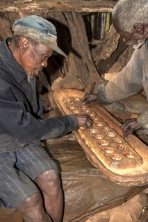 Two men from the Konso ethnic group play the board game Gebeta, a variant of the Mancala board