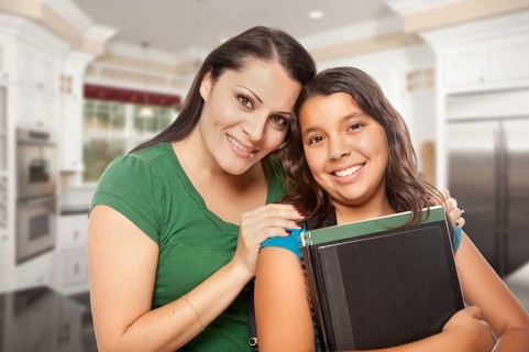 Proud Hispanic Mother and Daughter In Kitchen at Home Ready for School