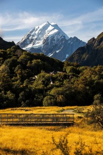 Stunning beauty of Mount Cook in New Zealand during autumn. Golden foliage and clear skies create a