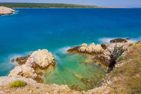 Romantic view over the sea in Koromacna Bay on a sunny day with rough seas on the island of Cres,