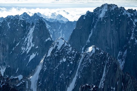 Snow and ice, epic mountains with steep cliffs, aerial view, Alaska Range, Denali National Park,