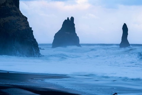 Reynisdrangar pinnacles, lava sandy beach, lava rocks, sea, waves, surf, blue hour, Vik, Iceland,