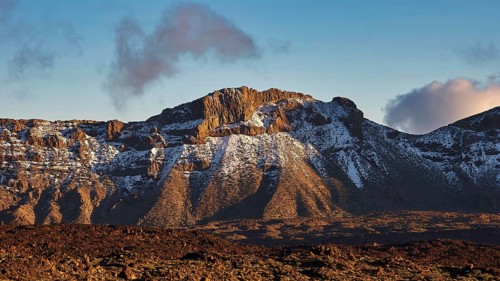 Mirador El Tabonal Negro, Caldera, snow-covered hilltop illuminated by the evening sun with