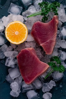 Fresh, raw steak, tuna fish, on ice, top view, close-up