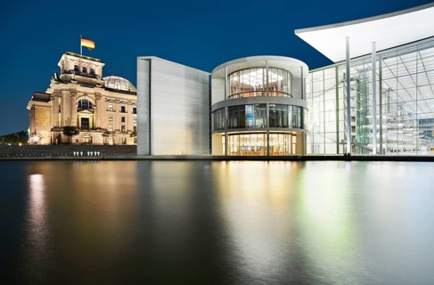 The Reichstag with the German flag and the Paul Löbe House of the German Bundestag on the Spree at